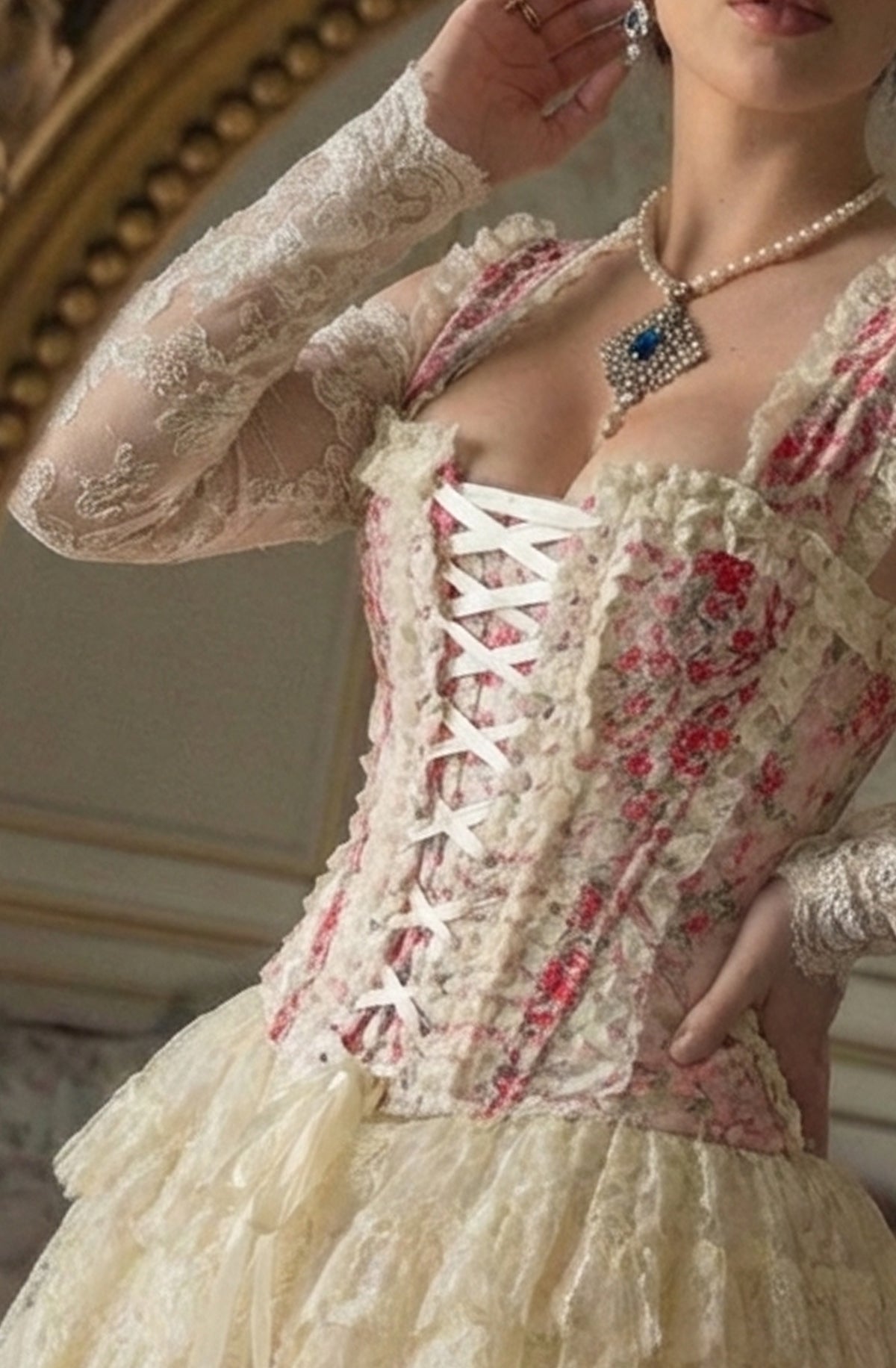 Vintage-style corset dress with floral details and lace, worn indoors.