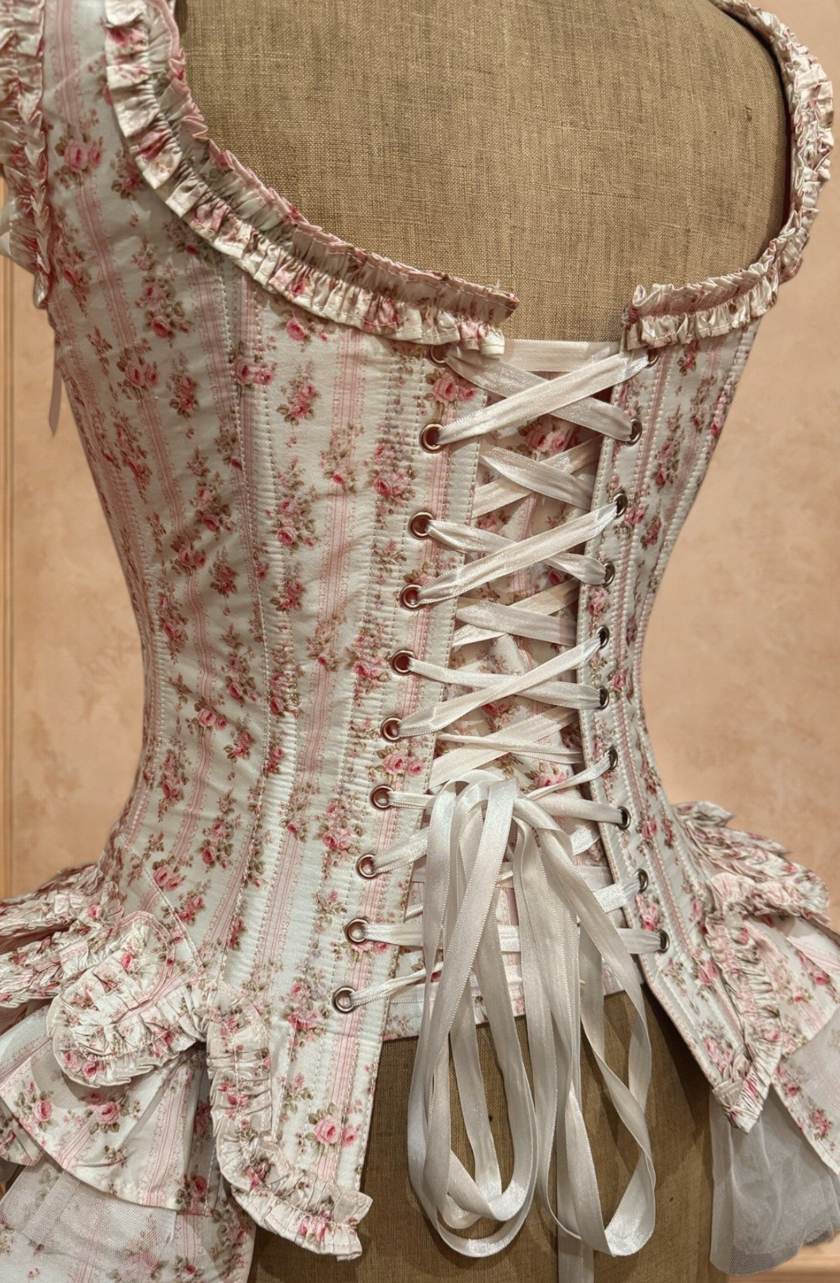 Floral corset with lace details on a beige background