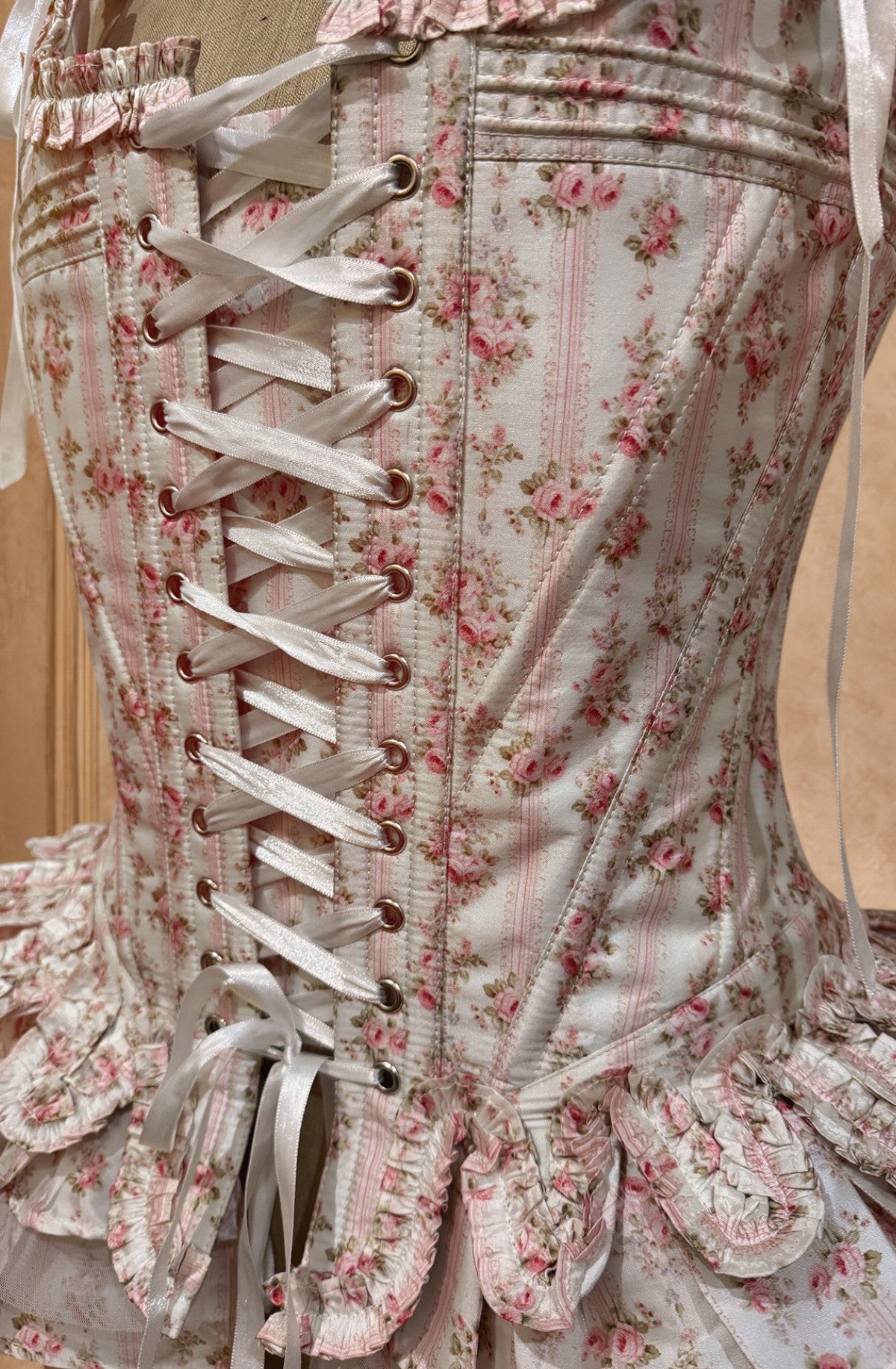 Floral corset with laces on a plain background