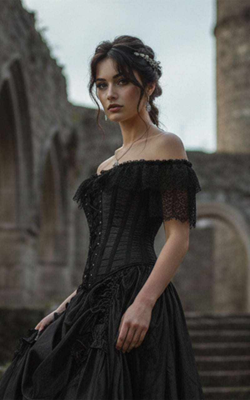 Woman wearing a black gothic lace corset and black satin skirt with intricate details standing in stone ruins