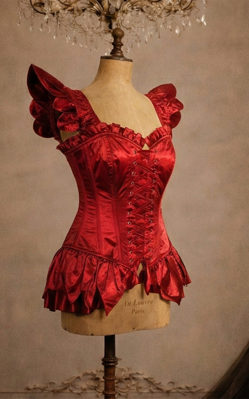 Red fairy corset  on a mannequin against a vintage wall with a chandelier - madame mortelle