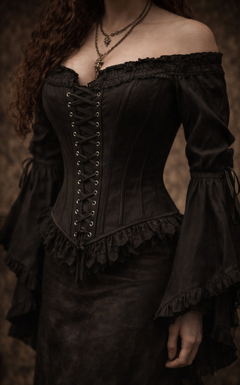 Black corset with intricate detailing on a dark background