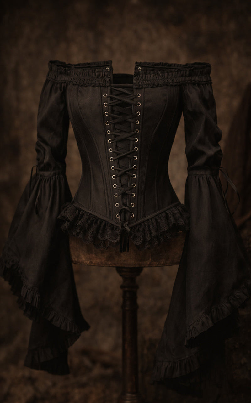 Dark Victorian-style corset on a mannequin against a textured brown background