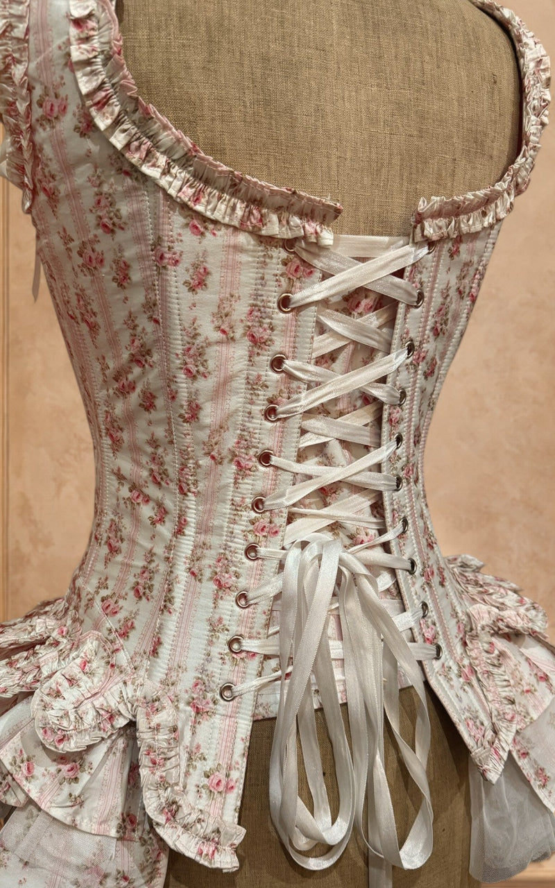 Floral corset with lace details on a beige background